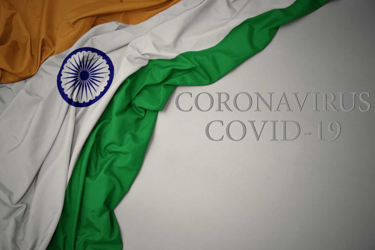 pandemic preparation waving colorful national flag of india on a gray background with text coronavirus covid-19 . concept.. COVID-19 cases in India illustration. Indian COVID-19 cases concept. Cases of COVID-19 crisis in India concept. Image credit: luzitanija / 123rf. Used to illustrate one million deaths due to the pandemic. covid-19 vaccine supplies in india, oxygen shortage. Long COVID concept. Omicron